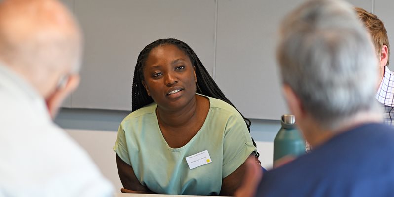 A student and families with dementia talking at an event