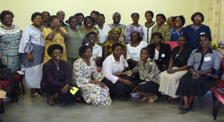 A group of people posing for a team hospital inside a hospital setting