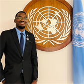 A photo of Gamma Msagama, Global Health MSc alumnus, smiling at the camera