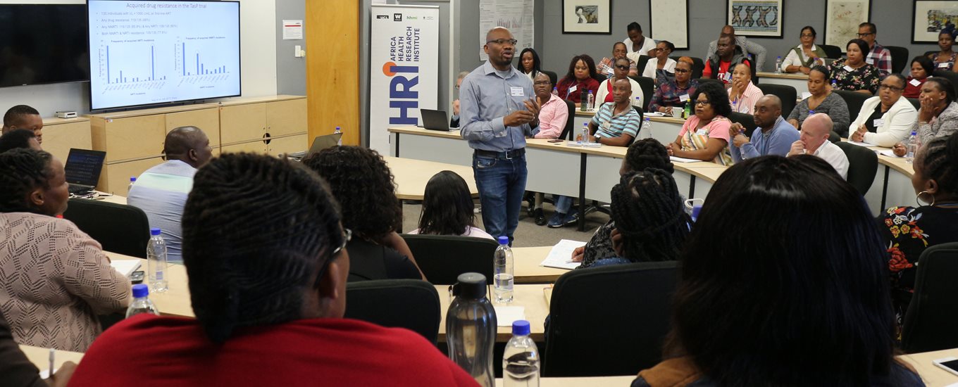 Presenter showing graphical data at the Africa Health Research Institute conference