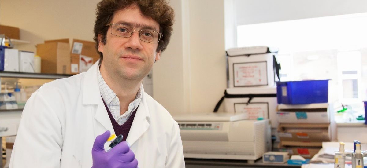 Simon Wadell wearing a lab coat in the research lab