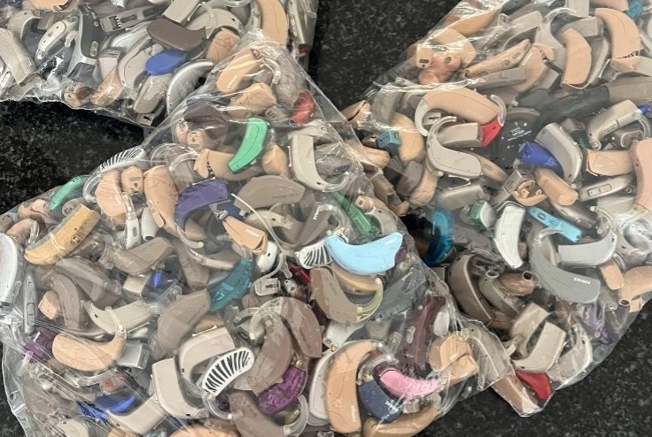 Clear plastic bags filled with donated hearing aids