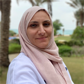 A photo of Mai Zakarneh, Global Health PGT student, smiling at the camera.