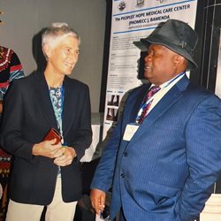 A man and woman laughing together at a conference in Cameroon