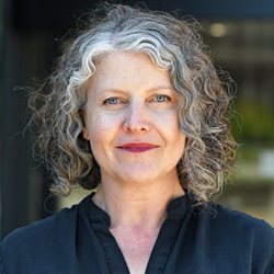 A woman named Alison Smith stood in front of a building smiling at the camera