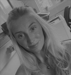A head and shoulders black and white photo of Harleigh Angel
