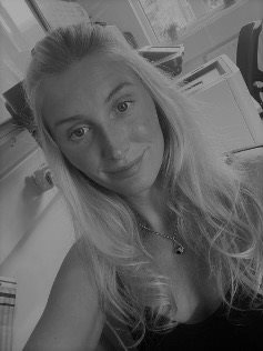A head and shoulders black and white photo of Harleigh Angel
