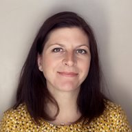 A head and shoulders photo of Katie Campbell, a staff member at BSMS, wearing a yellow top and smiling