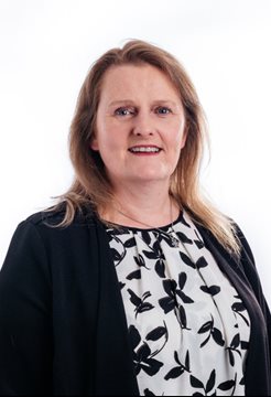 A head and shoulders of Mary Doherty from BSMS standing in front of a white background and looking at the camera