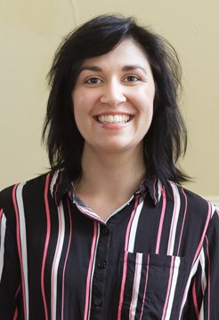 A head and shoulders photo of BSMS staff member Neena Shukla Morris in front of a cream wall