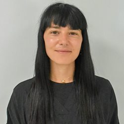 A close up of Nicoletta Moca from the anatomy team in black scrubs