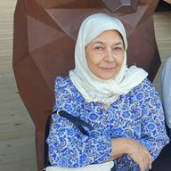 A profile photo of Saba Raza leaning on a statue or artistic sculpture