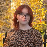 A head and shoulders photo of Sarah Lancaster in front of trees and a gate