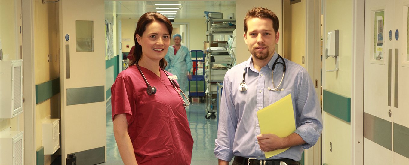 Two student final year doctors standing in a hospital ward