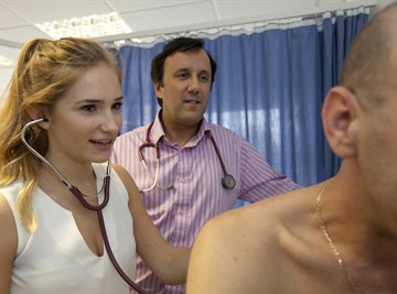 Female student listens to patients chest