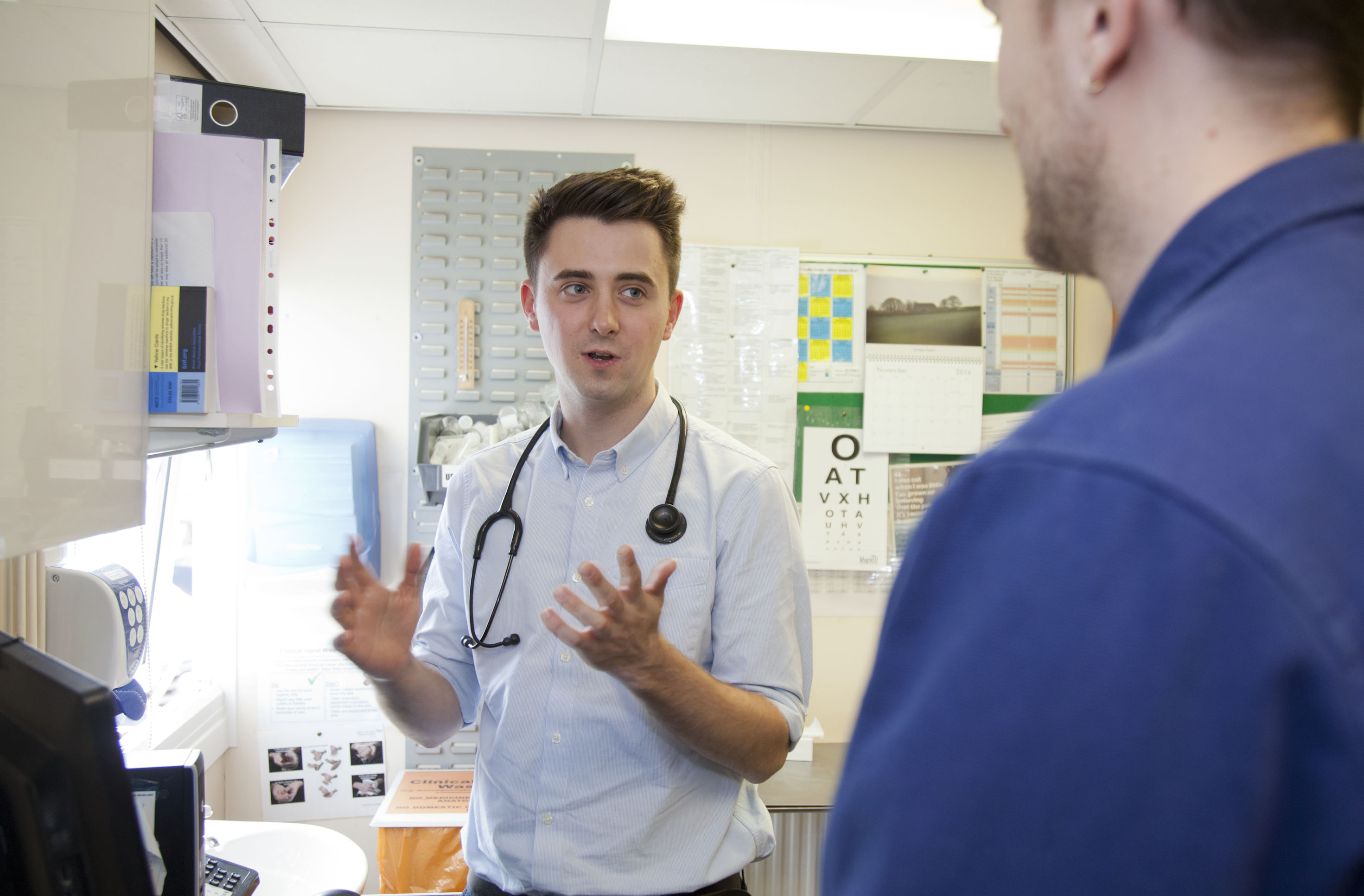 Sam Owen in a clinic with a staff member