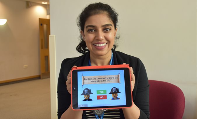 Anokhee Patel holds an iPad with her app displayed