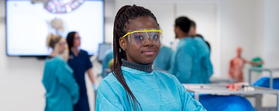 Ashley Chukwu in the dissection room (DR), a group of students behind her