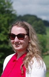 Harriet Sharp wearing sunglasses outside surrounded by trees