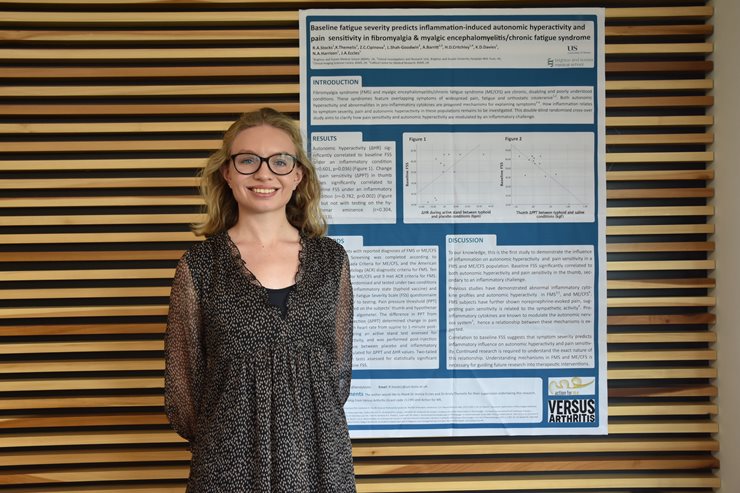 Robyn Stocks standing in front of her poster