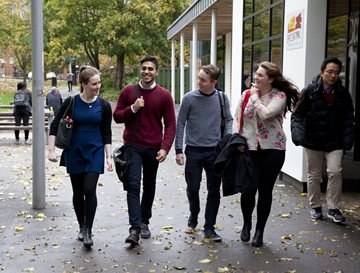 Four students walk through campus