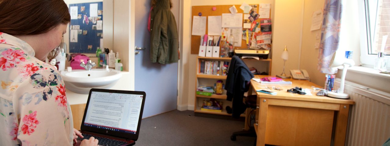 Female students on her laptop in her halls of residence