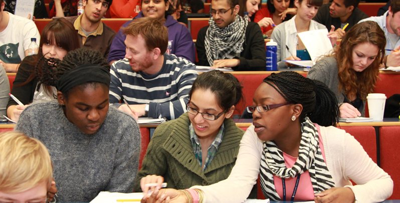 Students study  and chat in lecture theatre